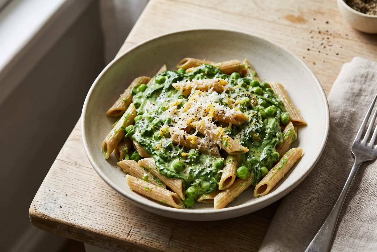 Whole-wheat penne in a creamy pea and spinach sauce